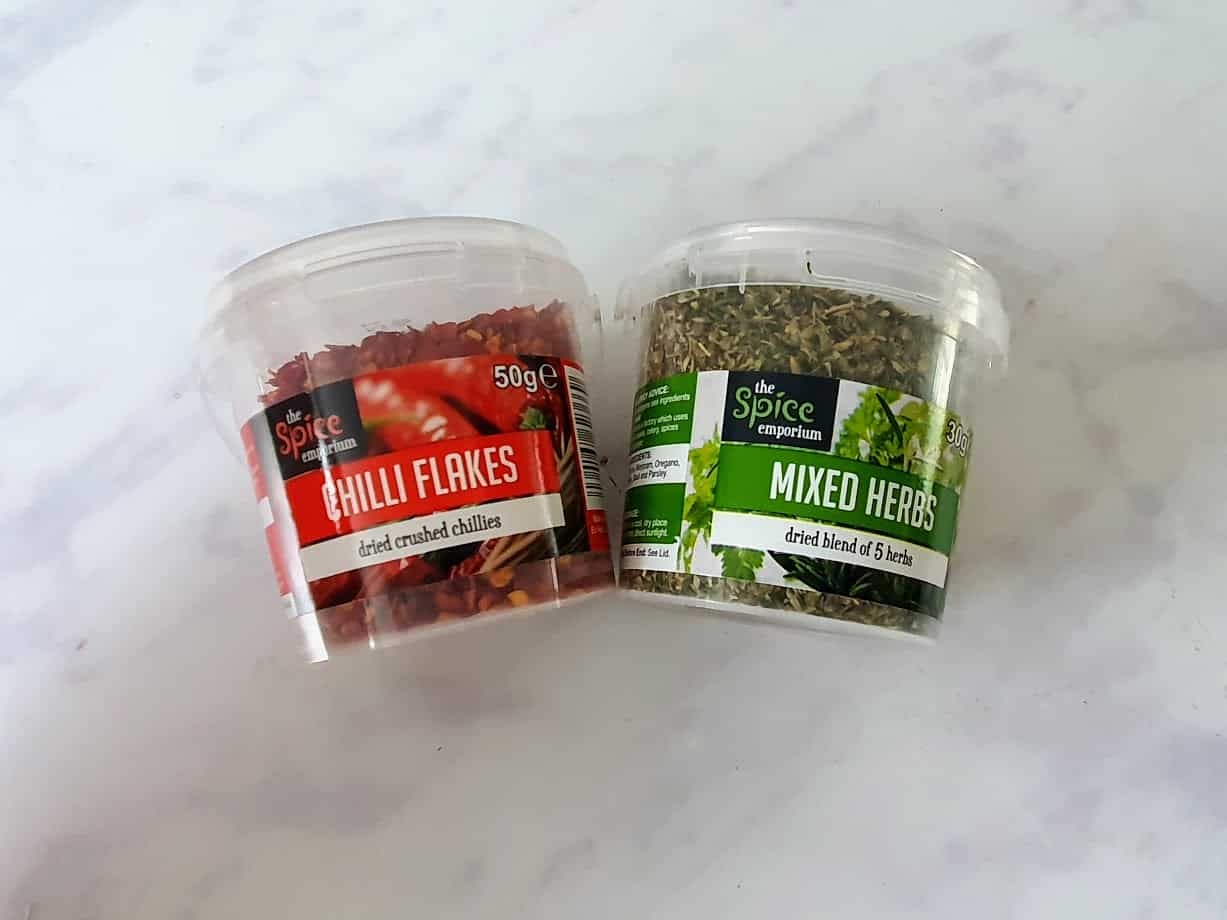 small pots of chilli flakes and mixed herbs