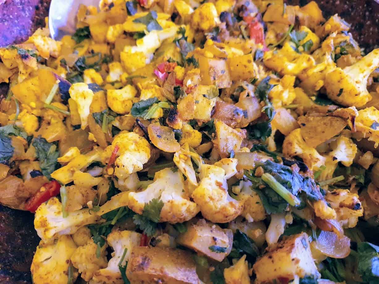 Frying pan full of cooked Aloo Gobi perfect for a Slimming World Indian syn free meal