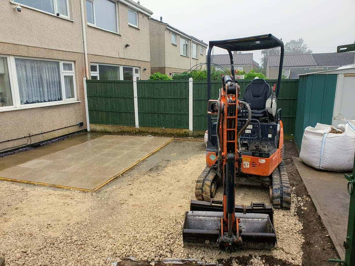 A digger at work in front of building
