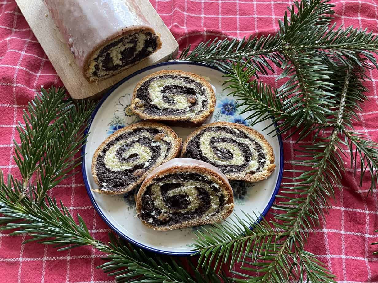 A plate with makowiec (recipe) and pine branches on it.