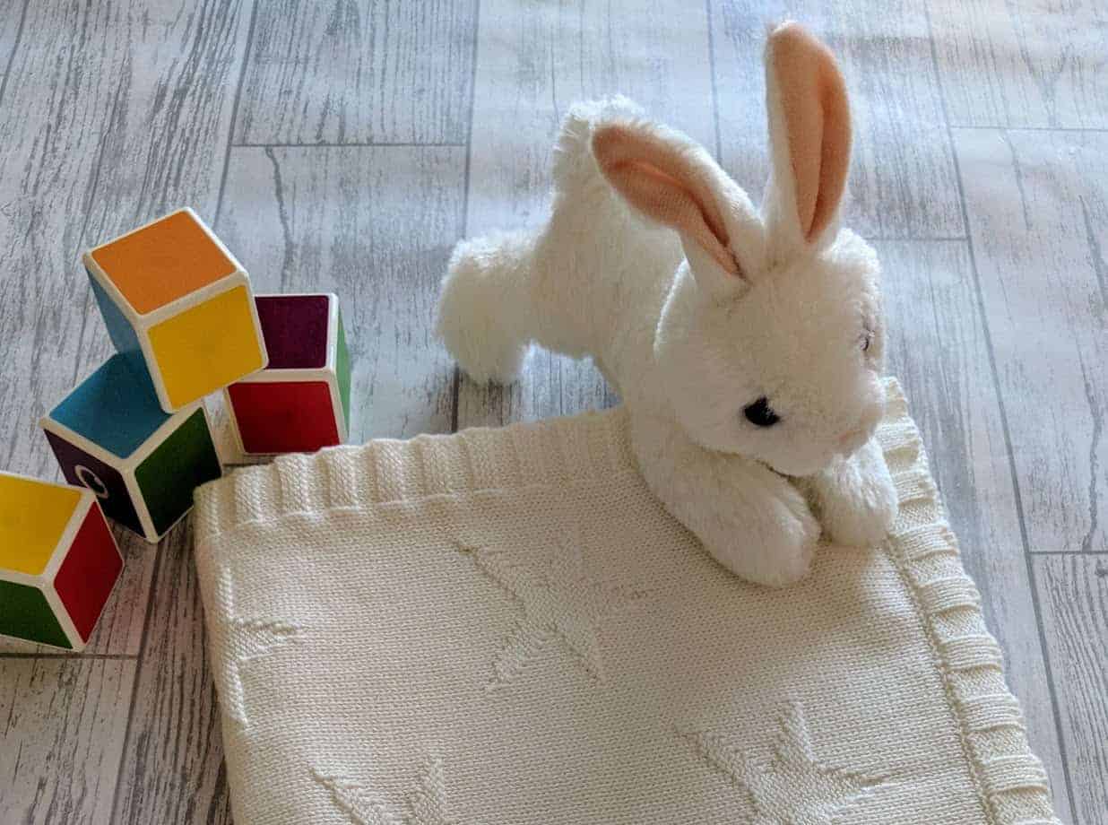 White bunny, baby blanket and building blocks