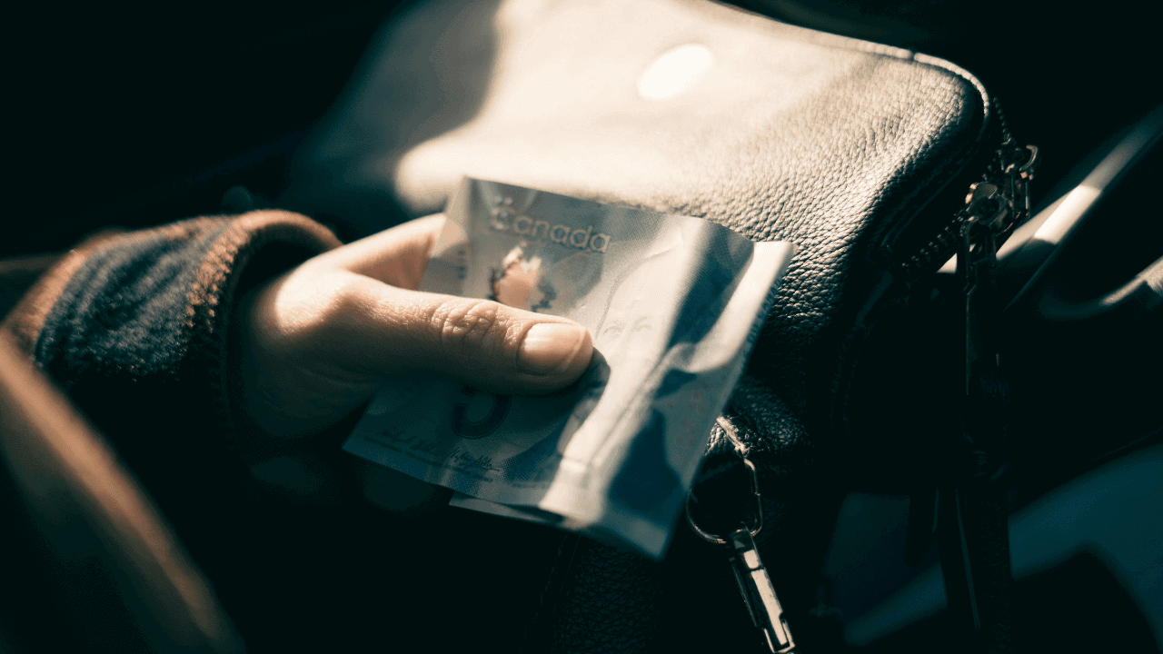 Canadian Holding a 5 dollar bill