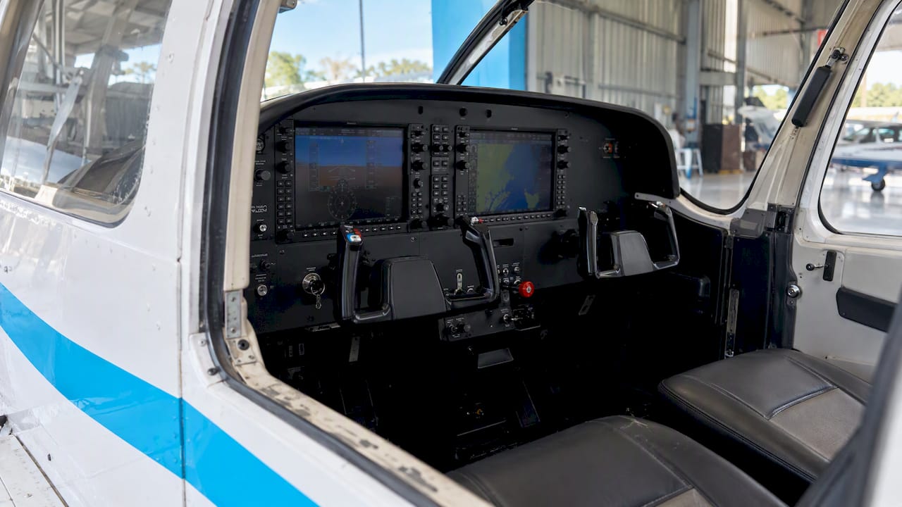 Glass flight displays inside an academy trainer cockpit