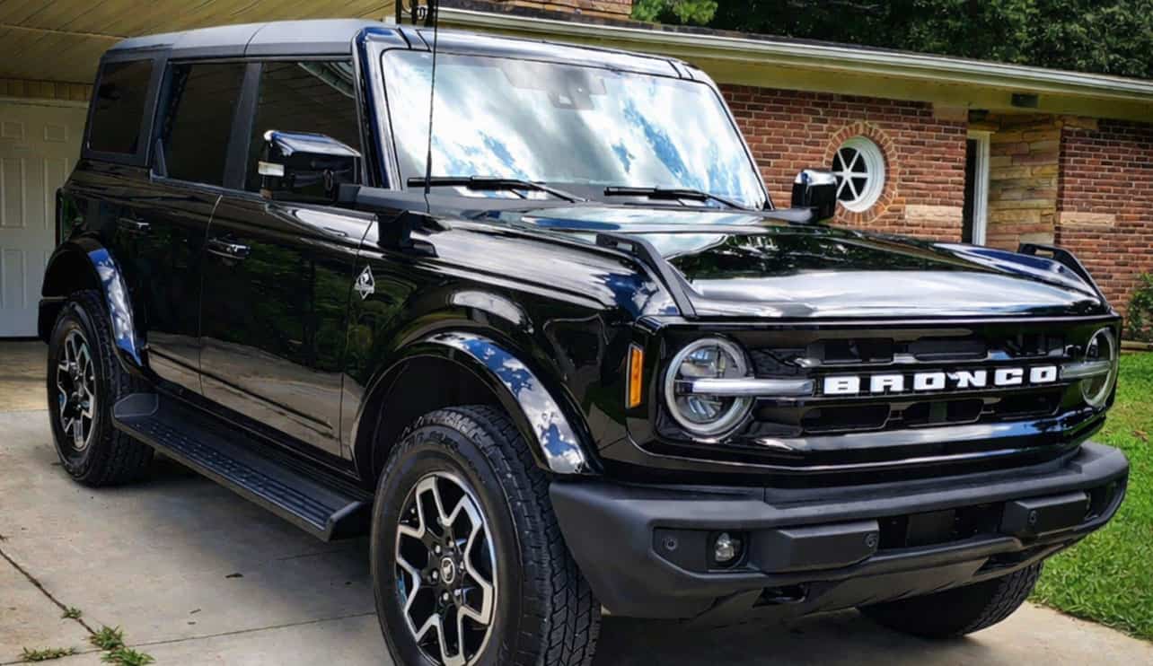 Shiny black SUV with ceramic coating parked on driveway
