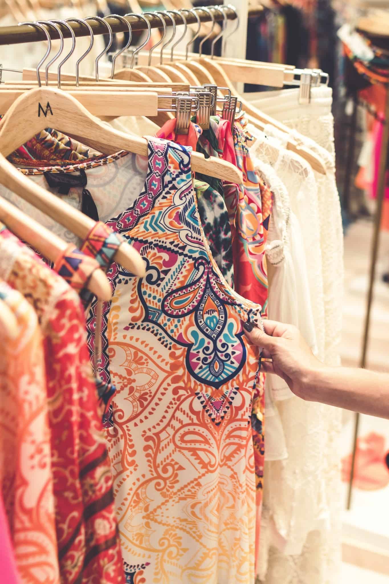 An array of colourful clothing on hangers