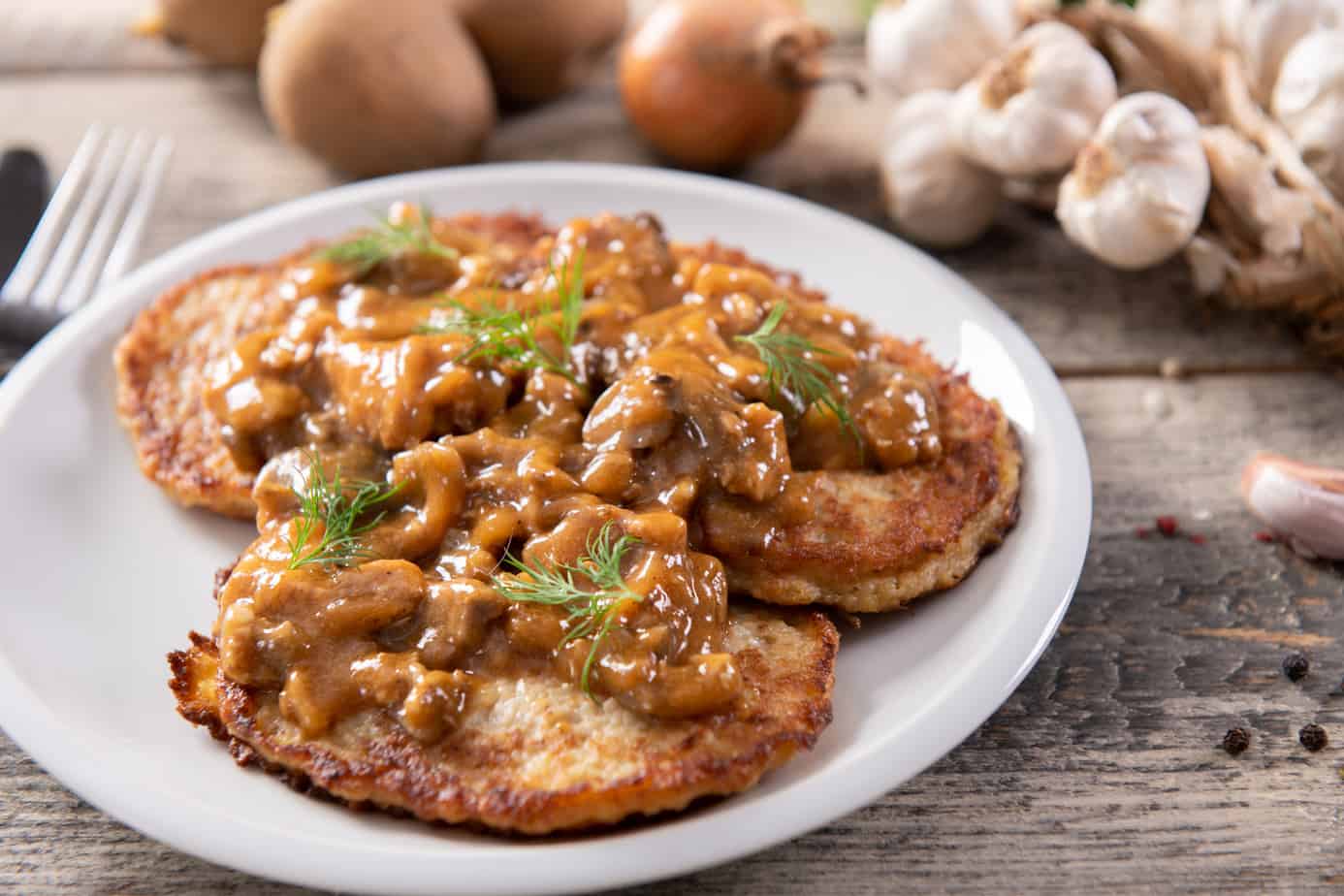 Potato pancakes covered with goulash.