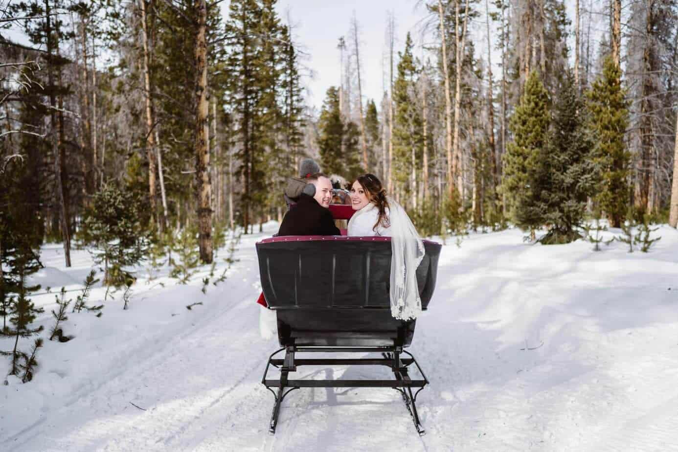 Bride and Groom in Horse-Drawn Sleigh Ride Winter Elopement Guide