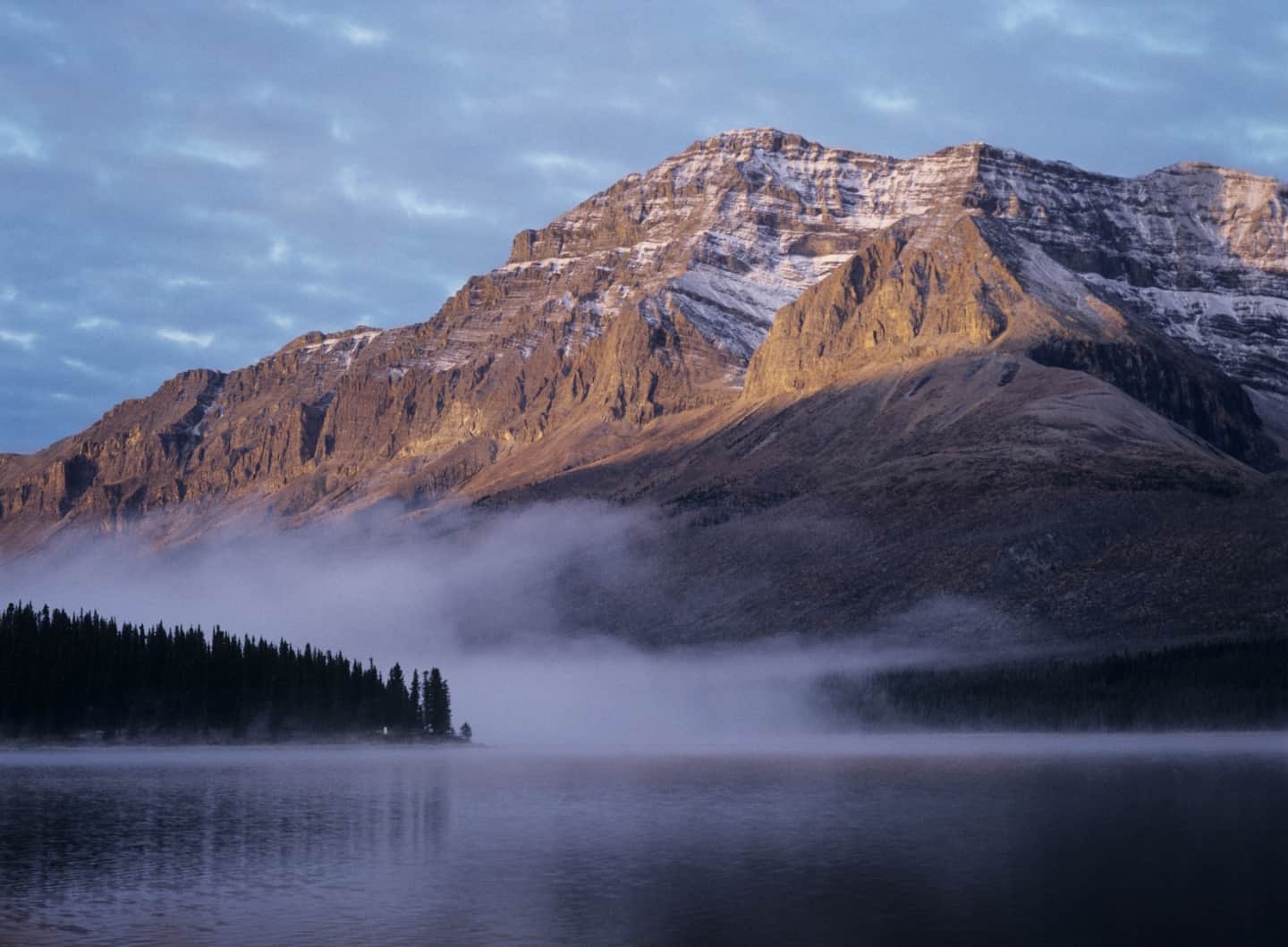 A lake with a mountain in the background