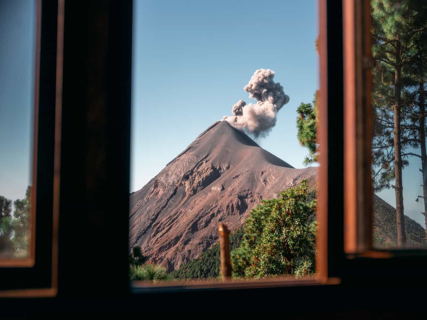Active Fuego volcano erupting as seen through the window of an OX Expeditions cabin at Acatenango