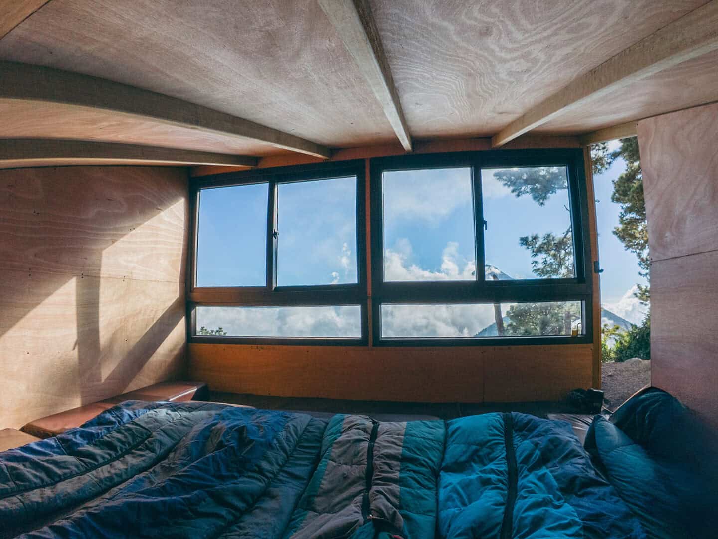 View from inside an OX Expeditions cabin looking toward Fuego volcano through large windows