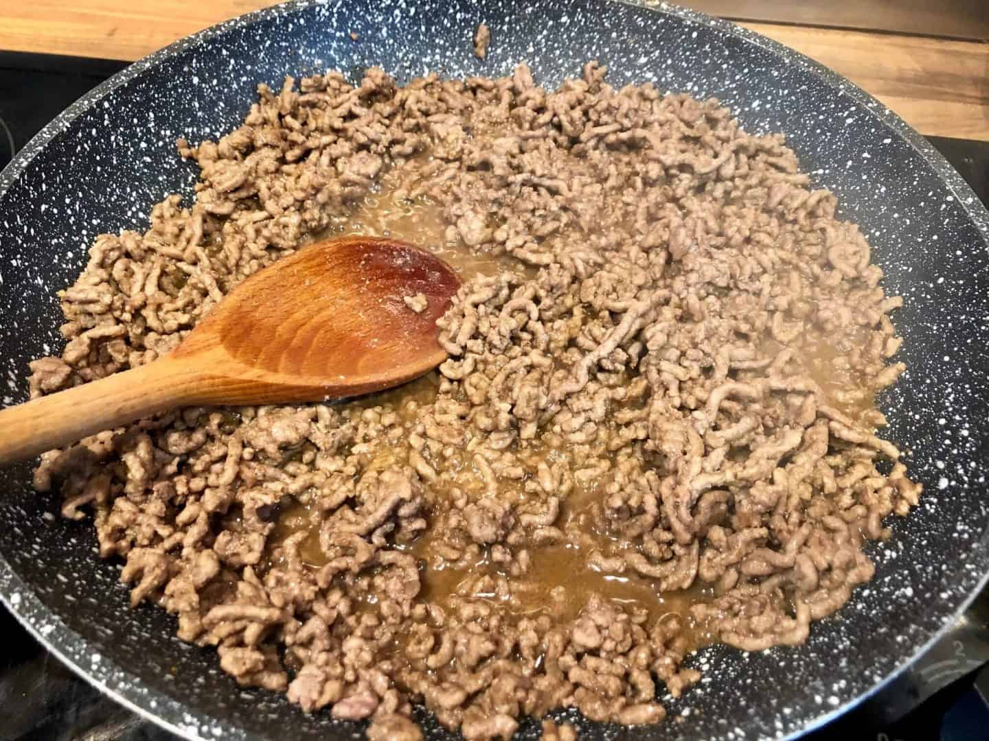 adding taco seasoning