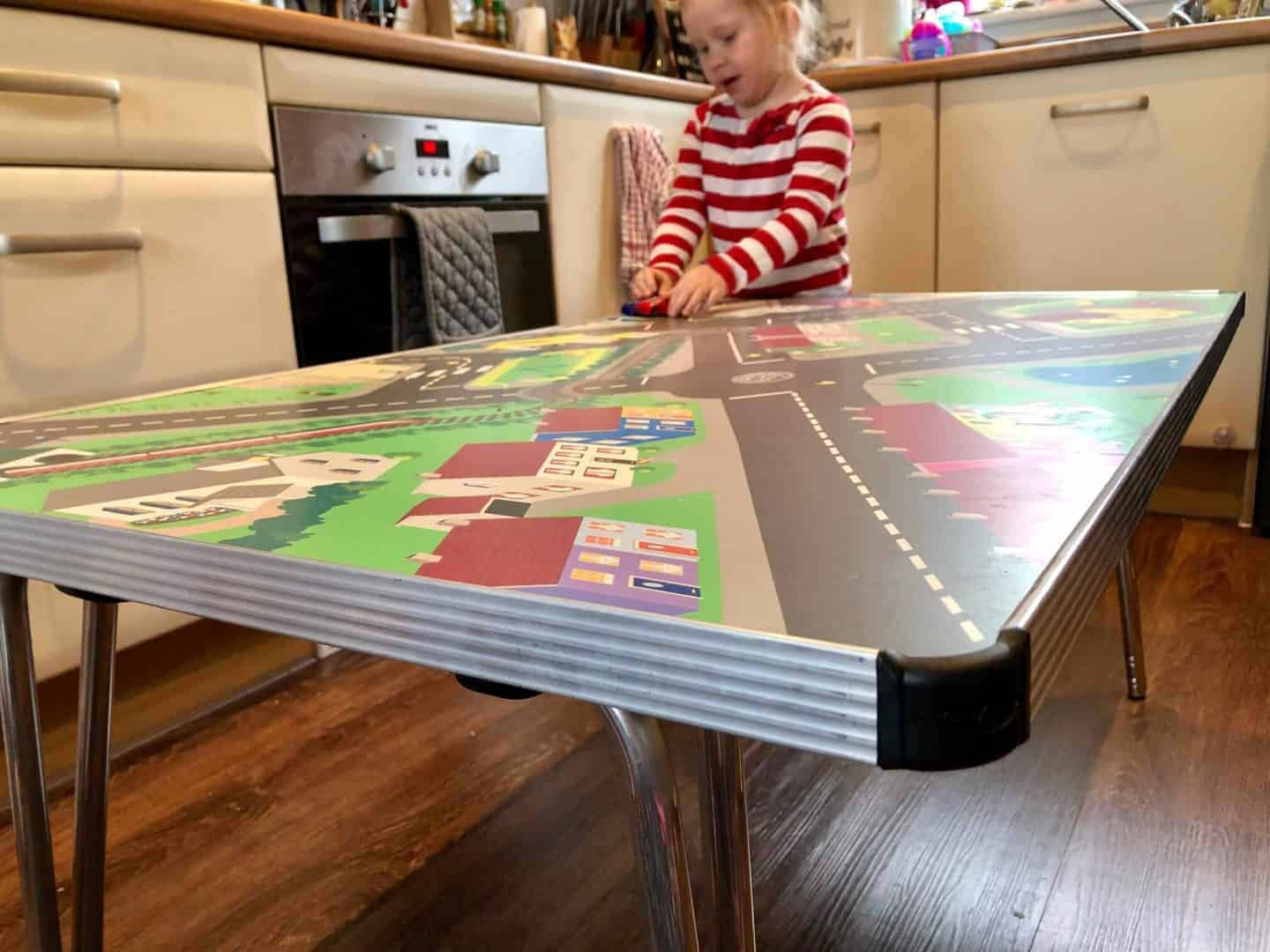 Playing with cars on the town activity table