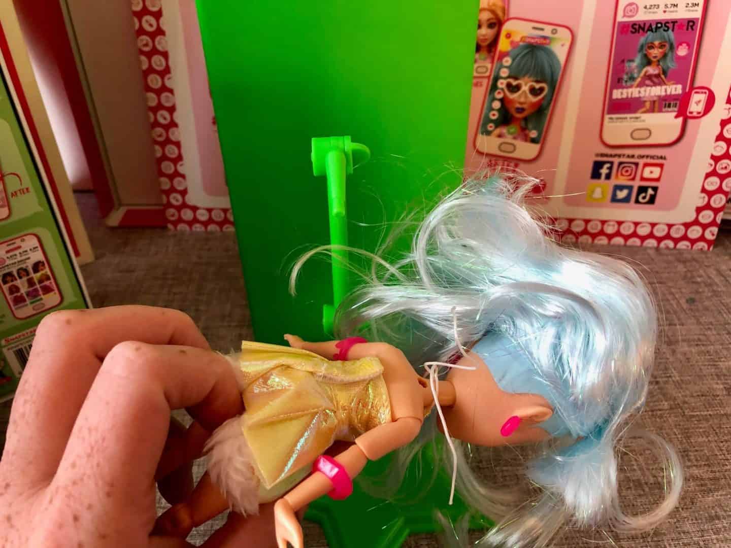 Fixing SNAPSTAR doll onto the doll stand