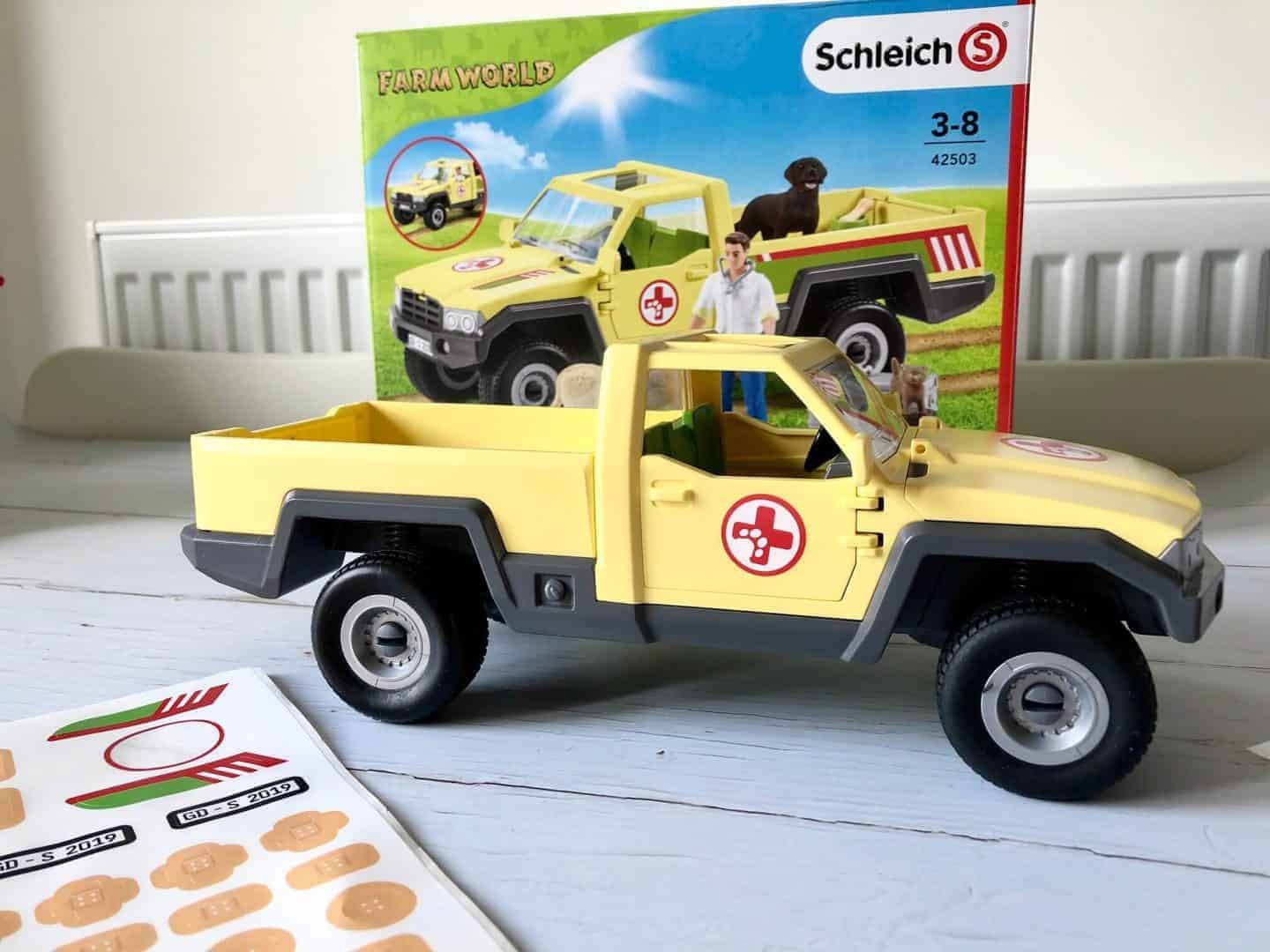 Putting the stickers in the Schleich Farm World  Veterinarian Visit at the Farm Pickup