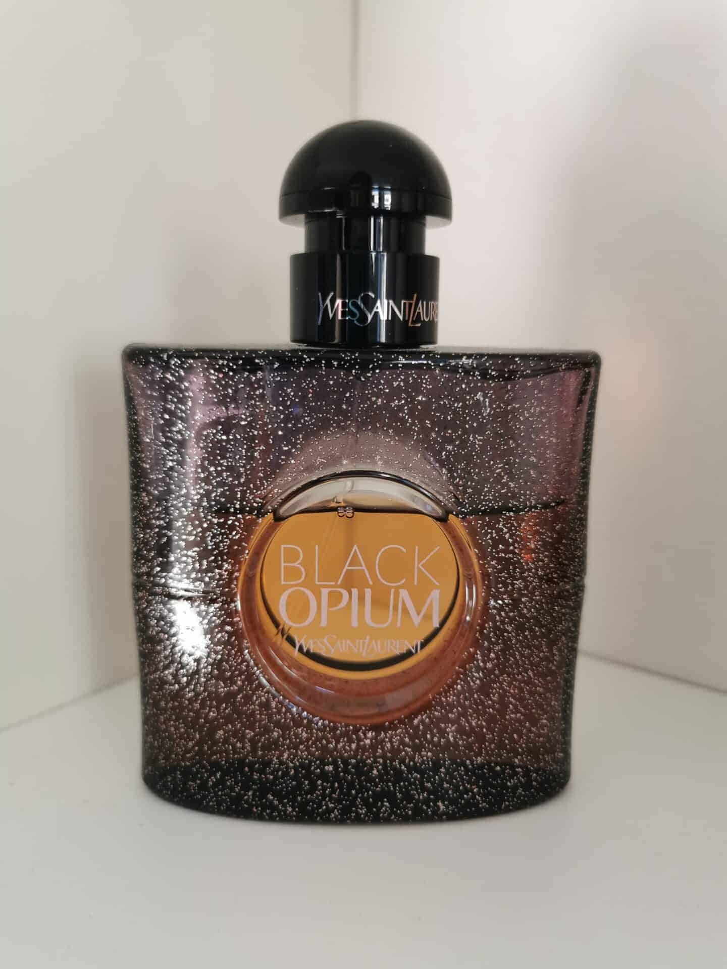 Bottle of black opium in front of white background