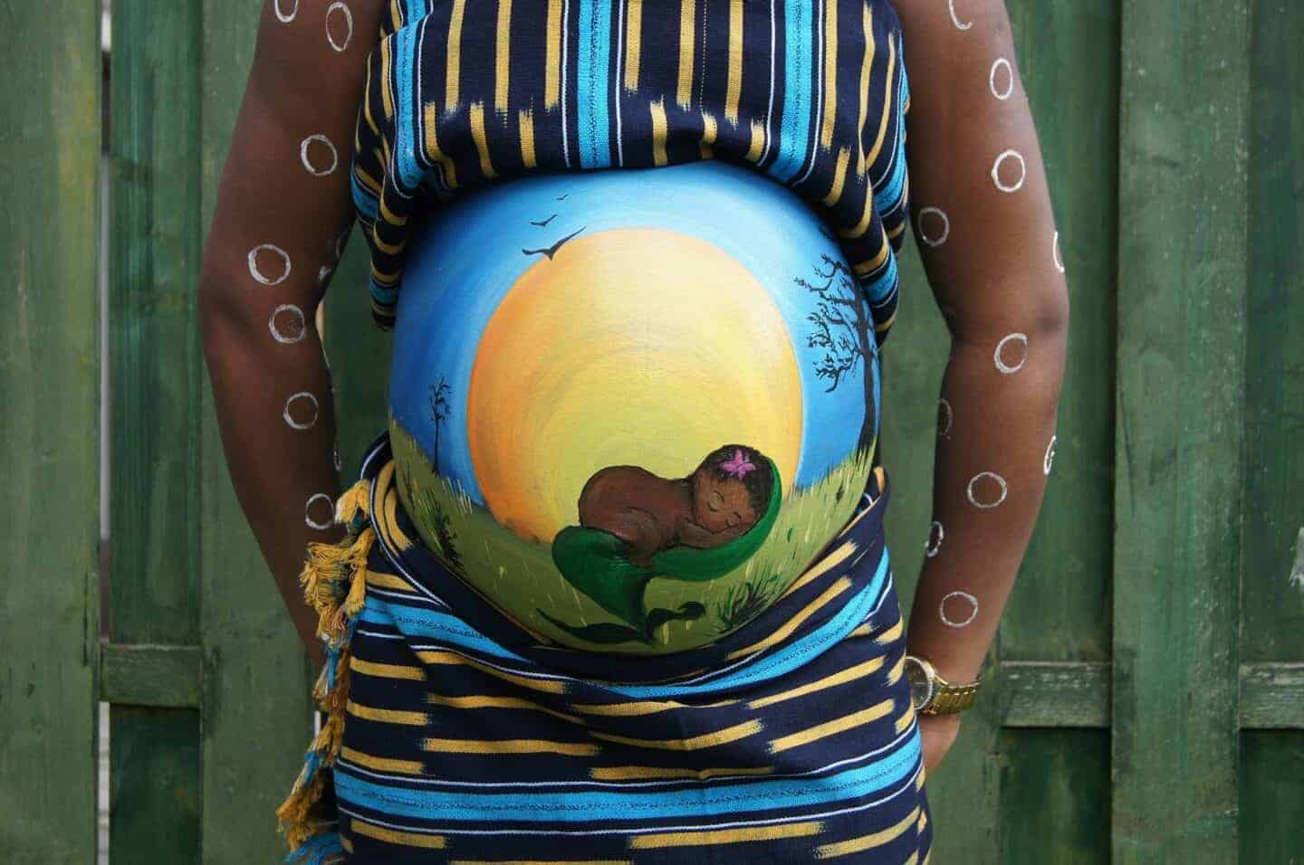 Black woman with painted baby bump