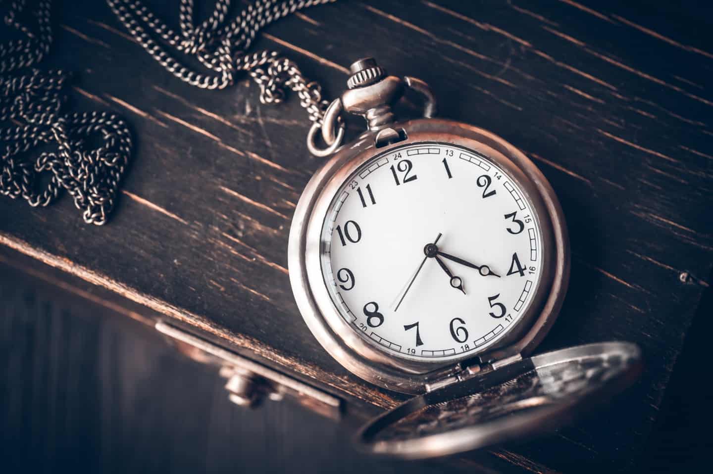 A pocket watch on a wooden background