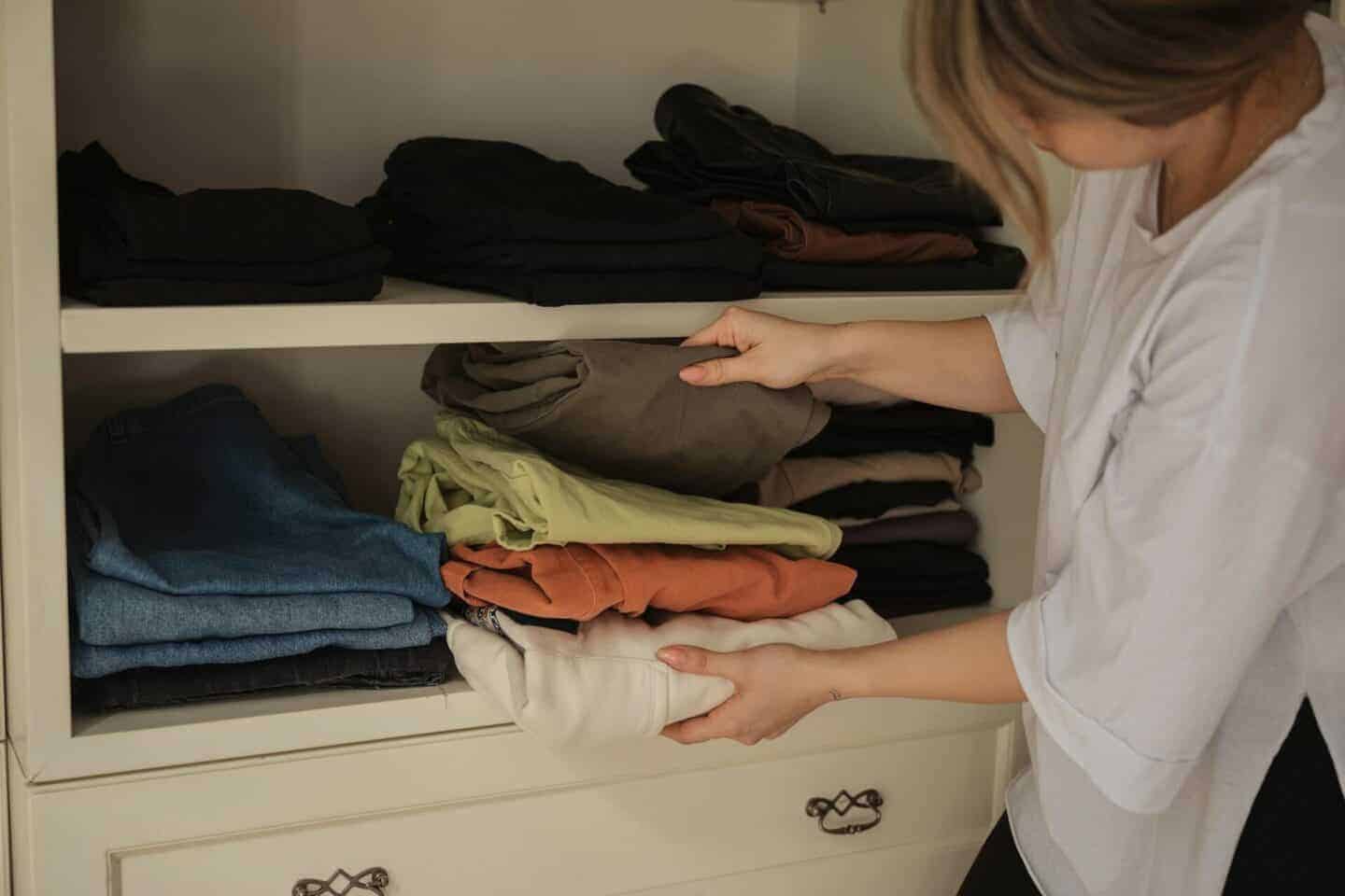 Adaptability and Longevity in Wardrobe Choices for pregnancy -Woman organising maternity capsule wardrobe 