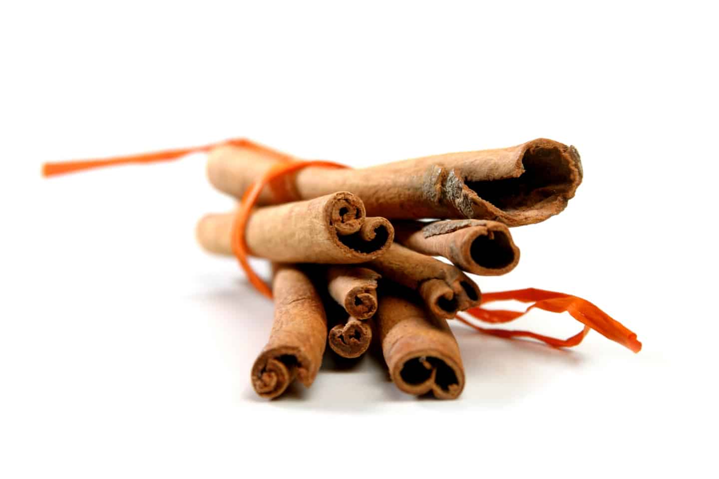 Cinnamon sticks tied with a small piece of coloured spring.