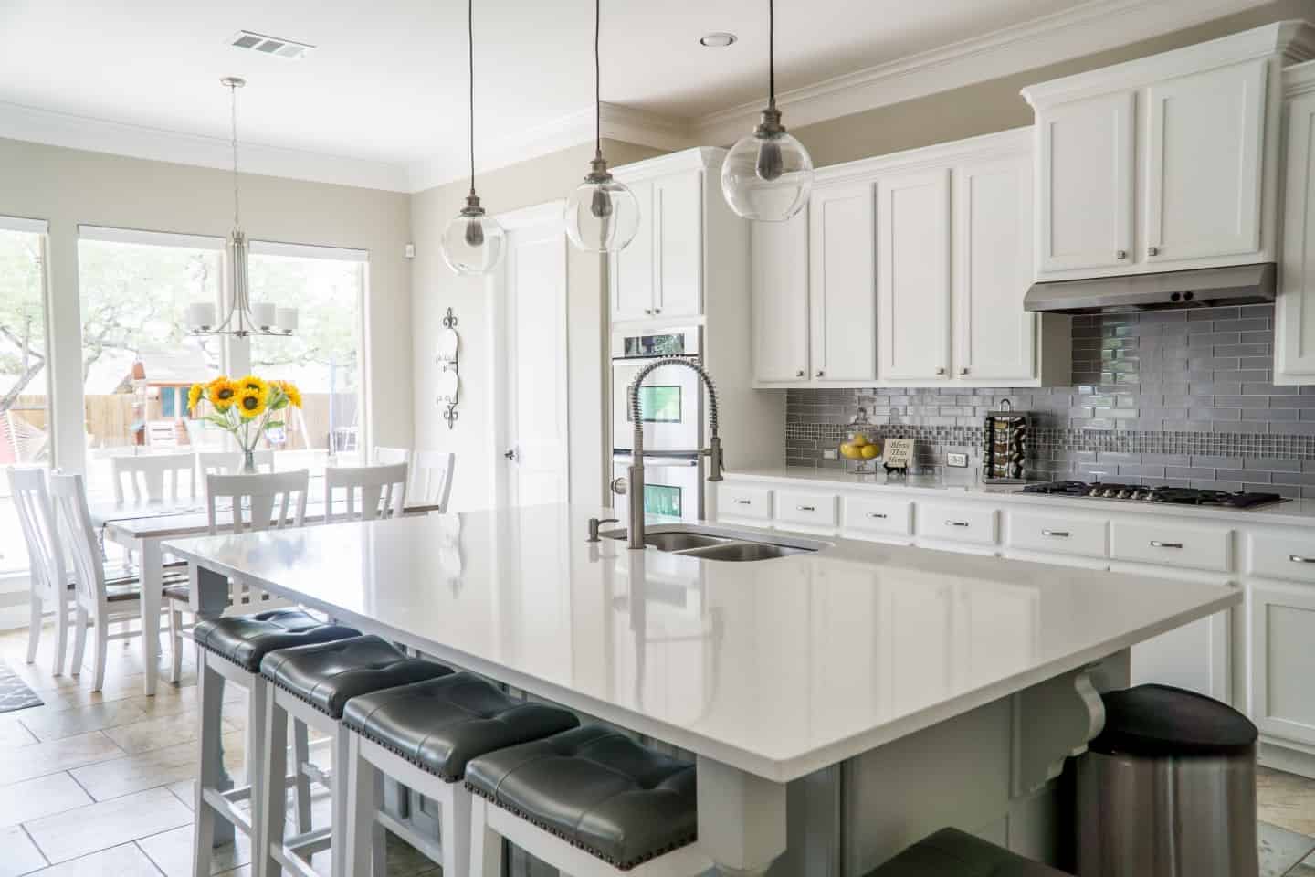 kitchen with white central island and white cupboards.