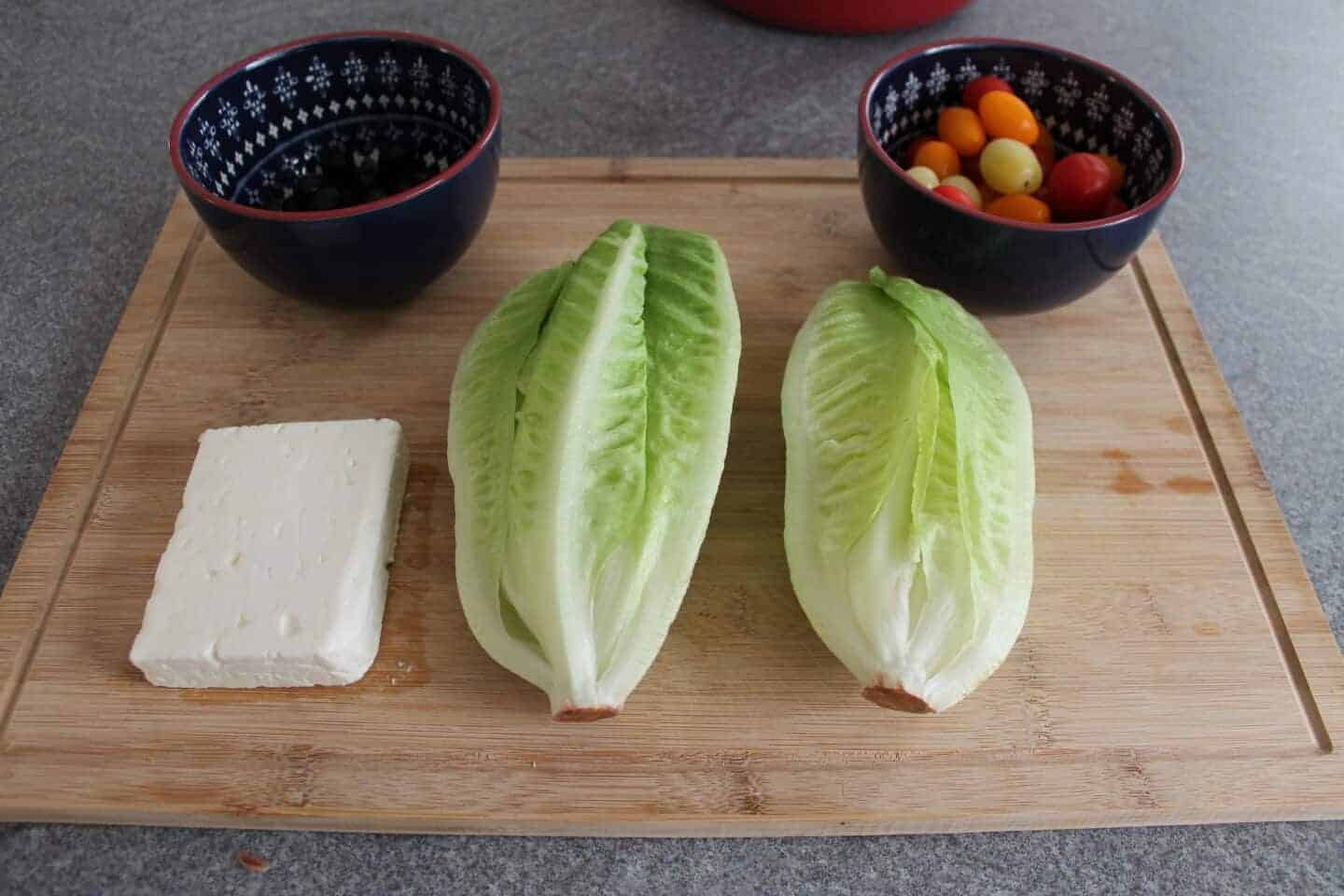 ingredients for greek salad on a chopping board