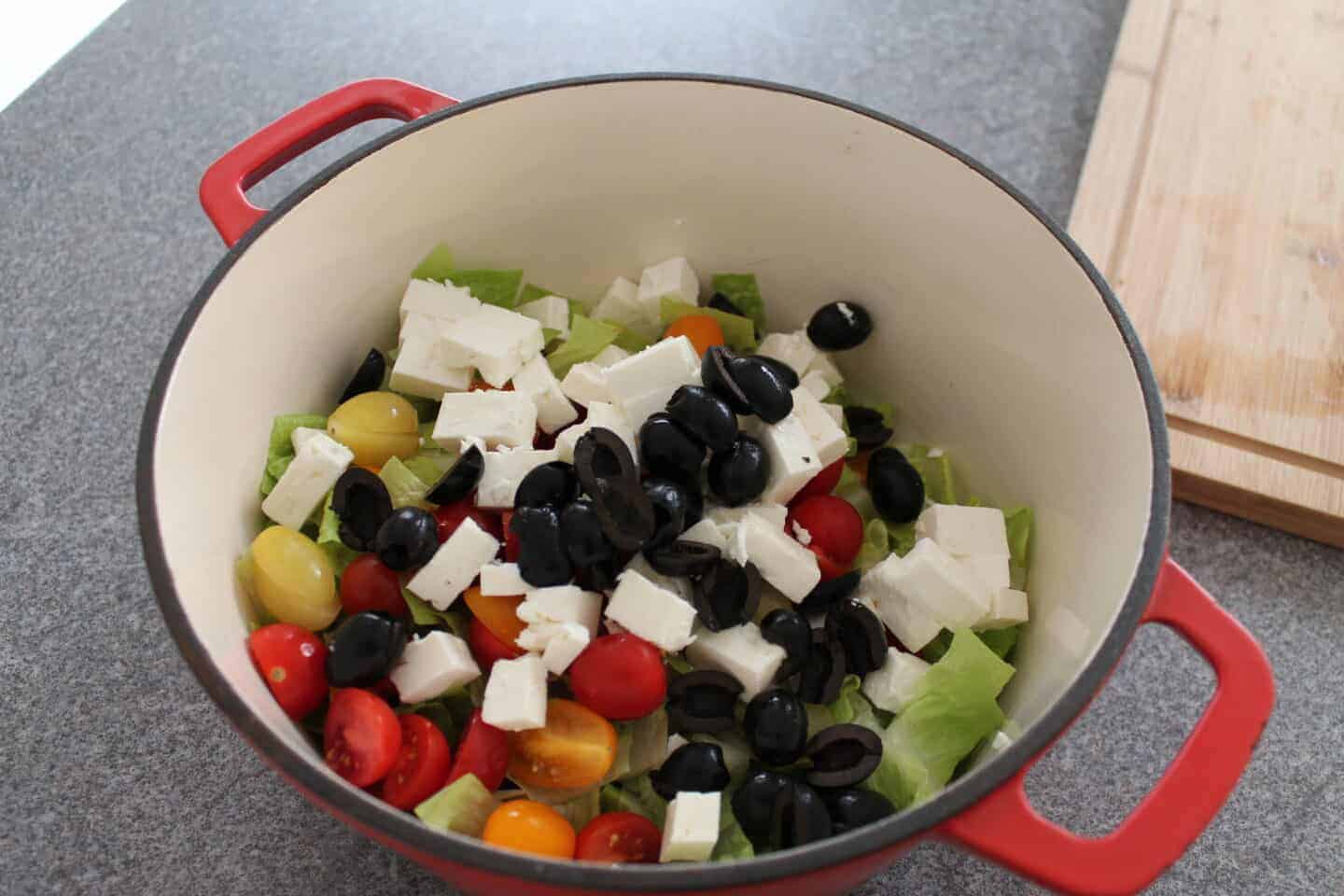 large bowl with all ingredients for the greek salad inside