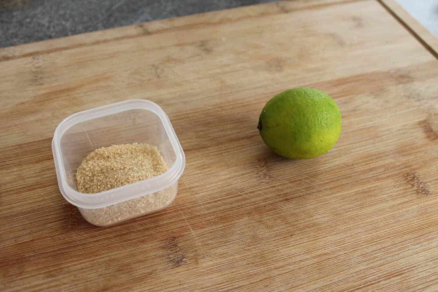 Lime and sugar on wooden chopping board