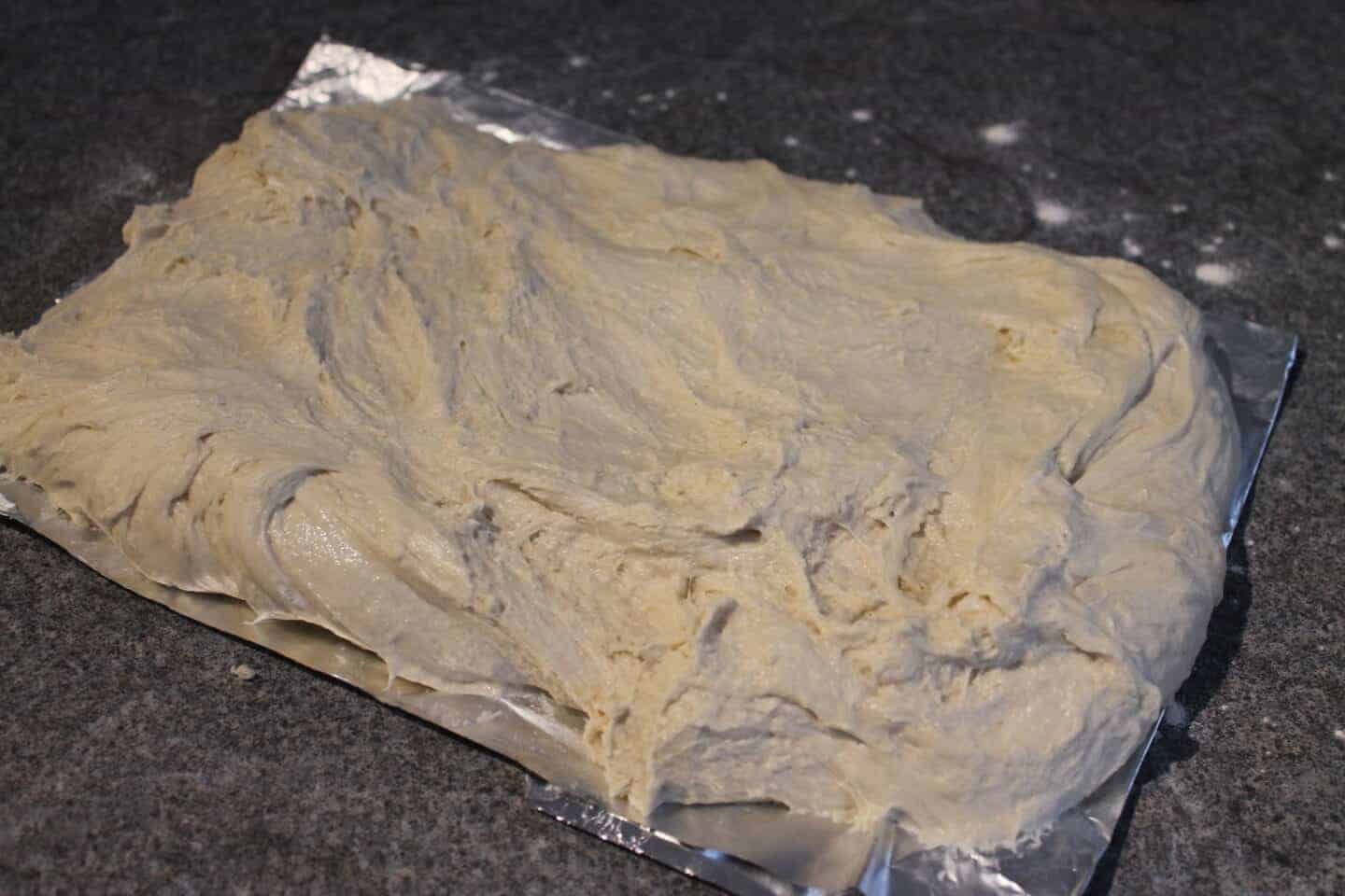 Pizza dough spread on foil