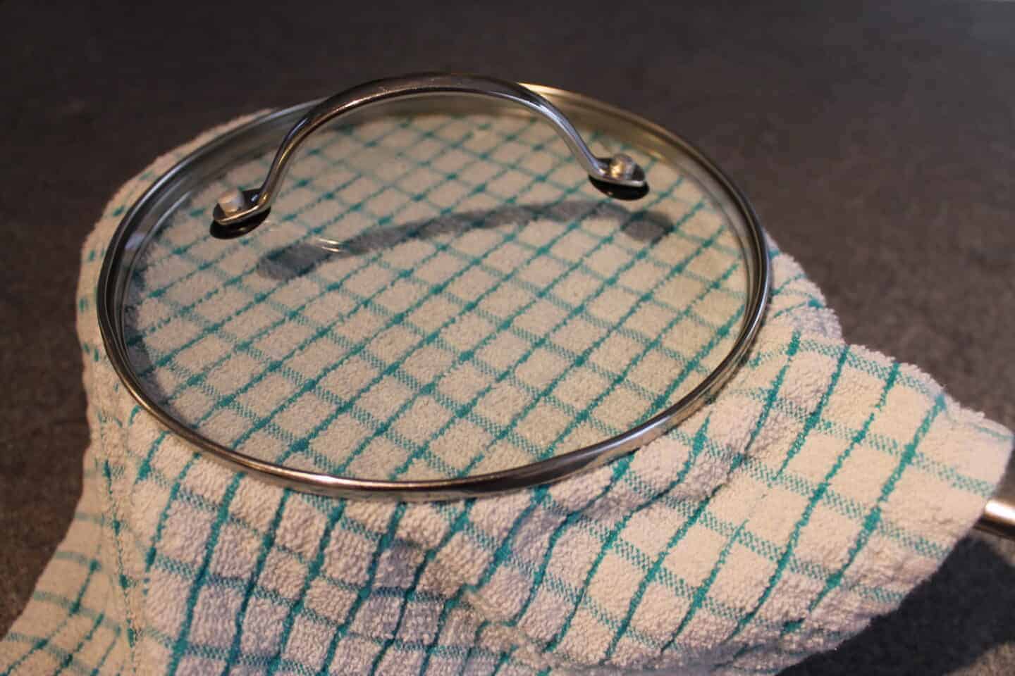 pan with a tea towel and lid on allowing mixture to rise