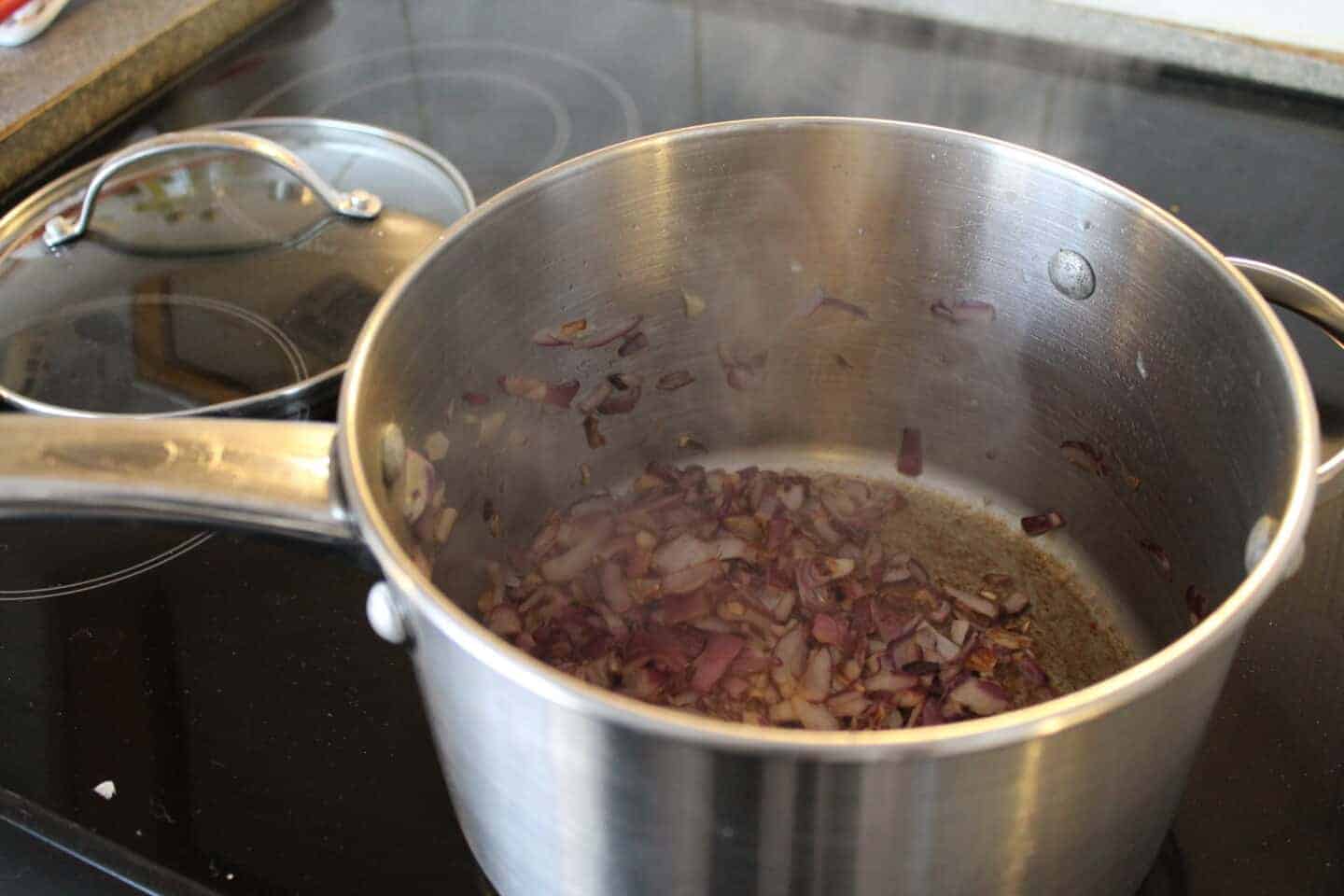 fried red onion in a large pan