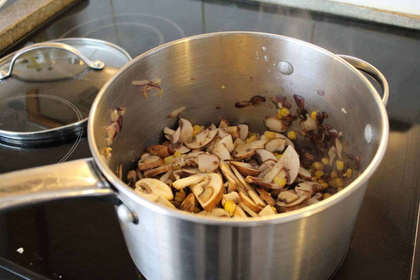 mushrooms, onion and sweetcorn in a large pan