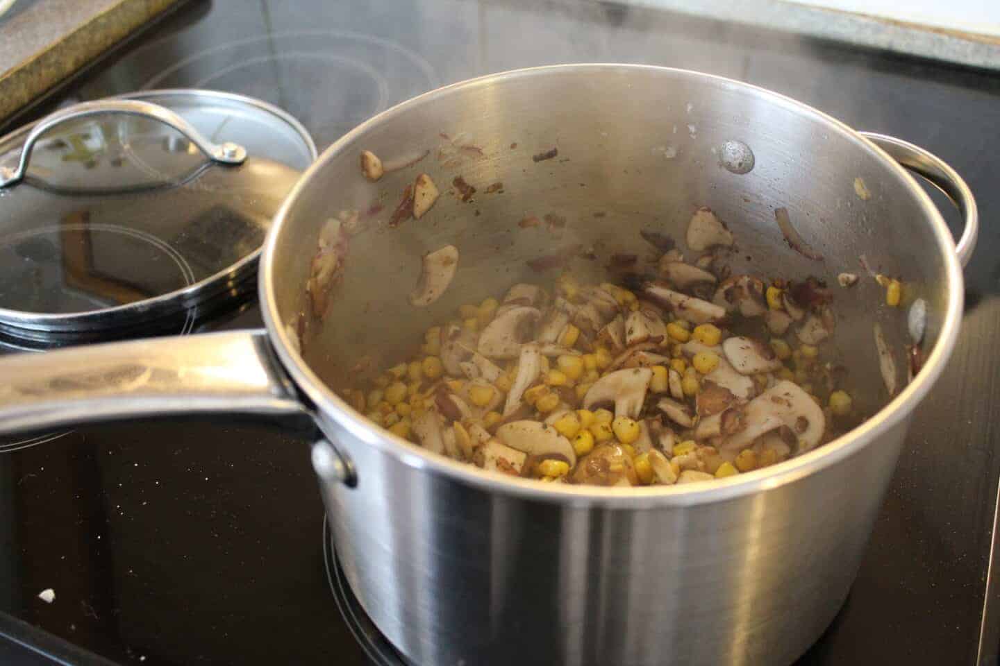 mushrooms, onion and sweetcorn cooked in a pan