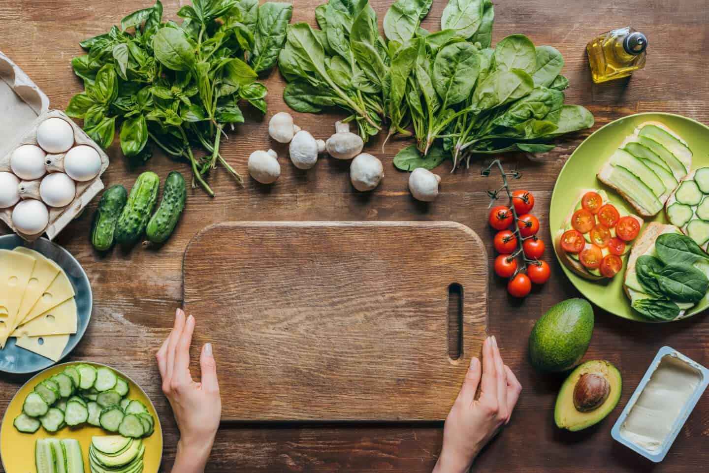 chopping board surrounded by vegetables