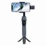 Gimbal stabilizer with smartphone attached capturing skiing action.