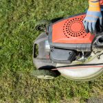 Gardener opened the mower's fuel filler neck