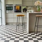 Cleaning Not letting dirt and spilt liquids to build upon your vinyl flooring in the kitchen is the best way for preventing any damage. You can do so by cleaning the floor regularly. Sweep the floors with a sweeping brush to remove grit, dirt, dust, crumbs and fallen hairs off of the floor. Opt for a cleaning solution sprayed on a mop for any spilt liquids or grease directly on the floor. When mopping the floor, avoid using too much liquid. Although vinyl flooring is liquid-resistant, it's still good practice not to drench the floor completely when mopping – it'll ensure the longevity of your kitchen floor. Long term care Vinyl flooring might resemble wooden flooring (depending on the type you have at home), but it does not require the same kind of attention as wood flooring. There is no wax polishing necessary as it can damage the topcoat of the vinyl. If you’ve got vinyl tiles in your kitchen and one of those gets damaged, you will probably be able to replace just that part of the flooring instead having to rip out the entire floor. However, always consult a specialist before doing any kind of installing or repairing. Lastly, make sure you use a special cleaning fluid that is made for cleaning vinyl floors. Especially stay away for any products containing bleach! To ensure your vinyl kitchen floors serve you a long time, a bit of care and maintenance is necessary. If you keep in mind the few tips provided in this post, you should be able to maintain beautiful floors in your kitchen with ease!