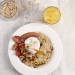 A breakfast plate features savoury porridge ideas like oatmeal topped with a poached egg, crispy bacon, mushrooms, and tomatoes, next to a refreshing glass of orange juice and a jar of oats.