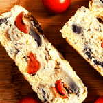 Breakfast quiche with cherry tomatoes on a wooden board