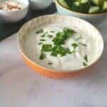 Garlic dip in an orange bowl