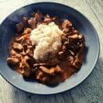 Beef stroganoff and rice in a grey bowl