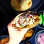 Roti in a hand.