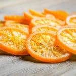 Candied oranges on wooden table
