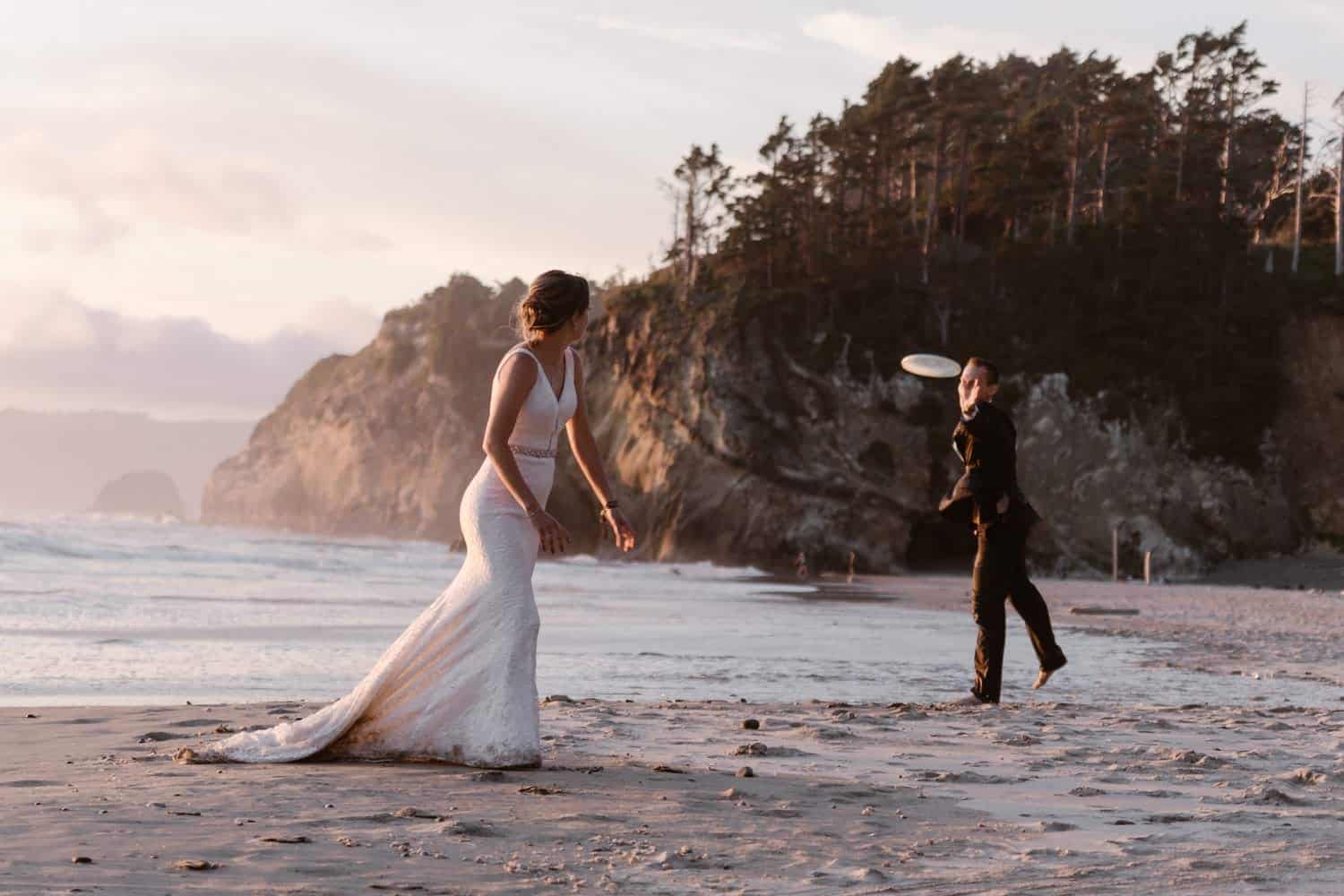 Bride and Groom playing frisbee at Hug Point & Cannon Beach Elopement
