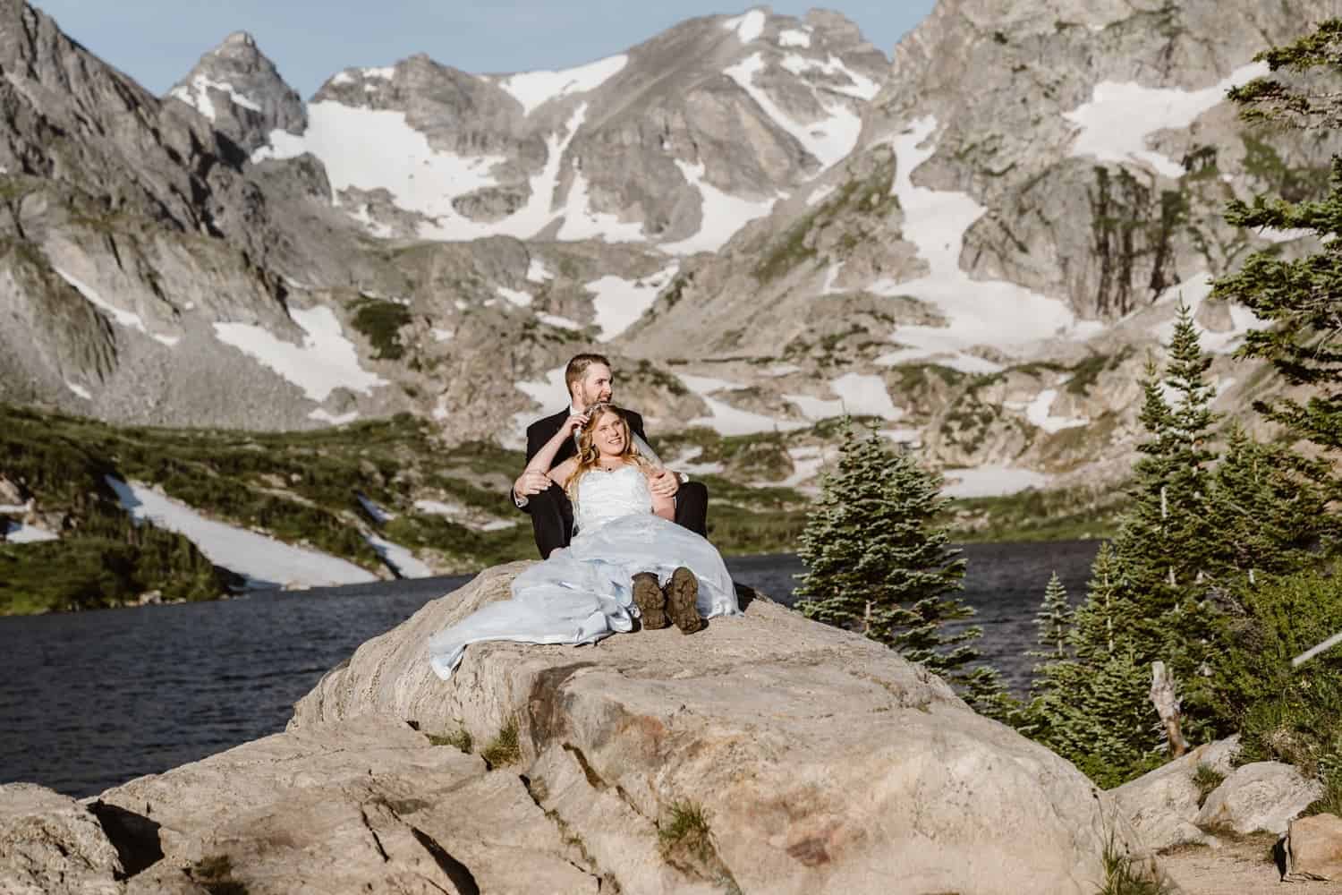 Bride and Groom Sitting on Rock at Adventure Colorado Elopement