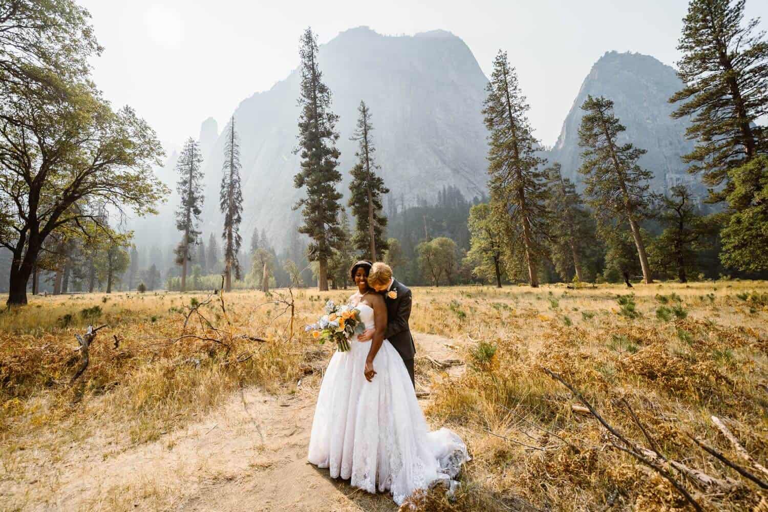 A couple sharing a hug in El Capitan meadow in Yosemite.