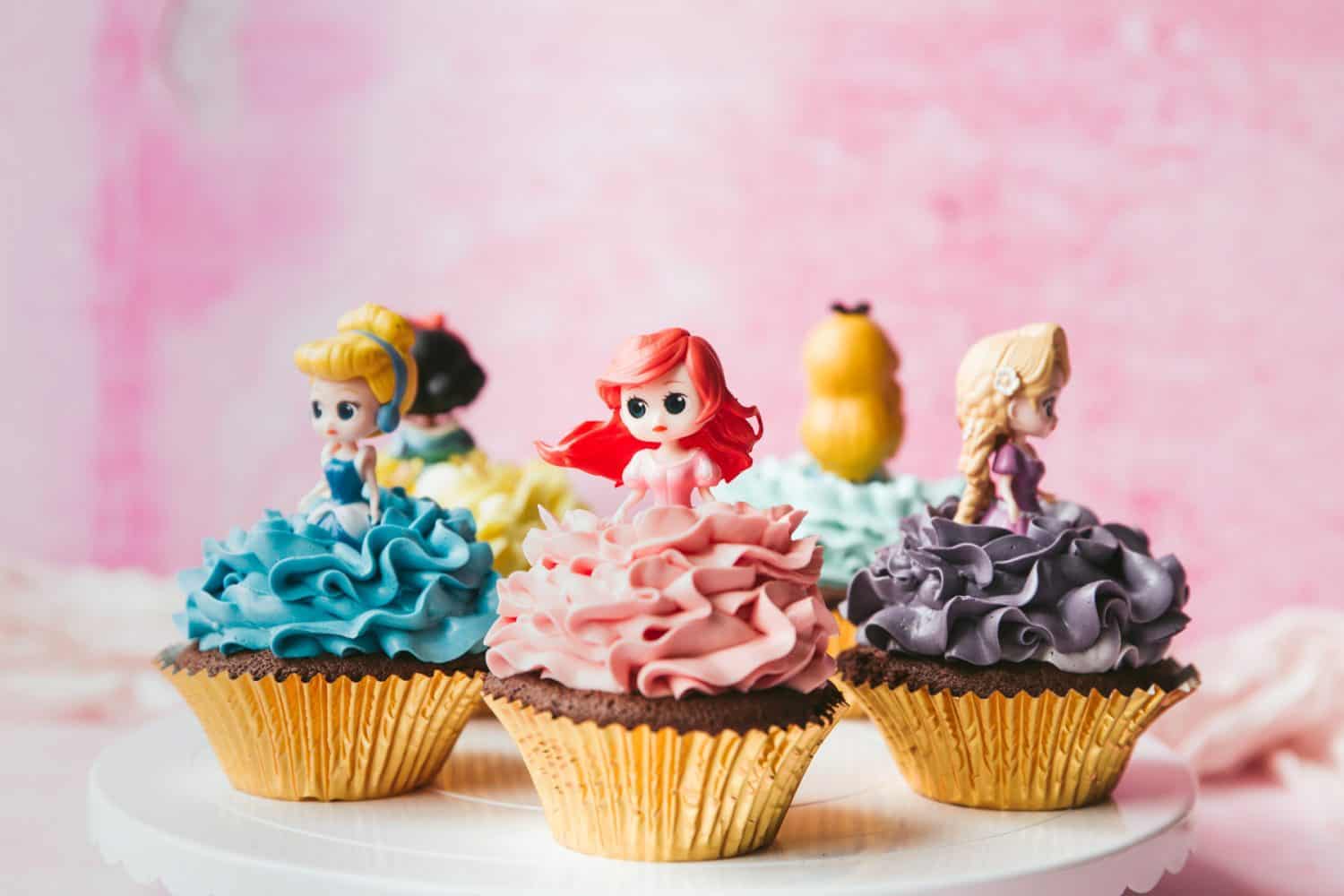 How To Make Princess Cupcakes | Coral's Blog - Food Blog - Cooking Guide 6 Two Disney Princess cupcakes sitting on chariot cupcake holders.