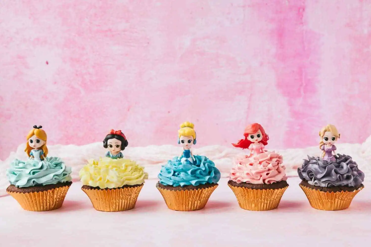 How To Make Princess Cupcakes | Coral's Blog - Food Blog - Cooking Guide 2 Disney princess Ariel on top of a chocolate cupcake covered in pink swiss meringue buttercream.