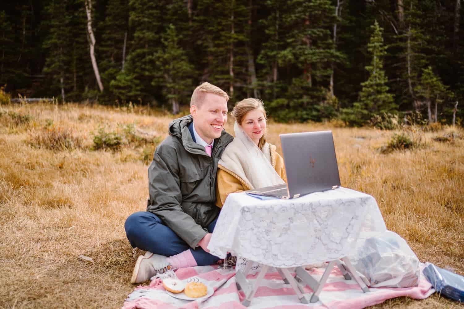 A couple sharing a facetime with their family on their wedding day,.