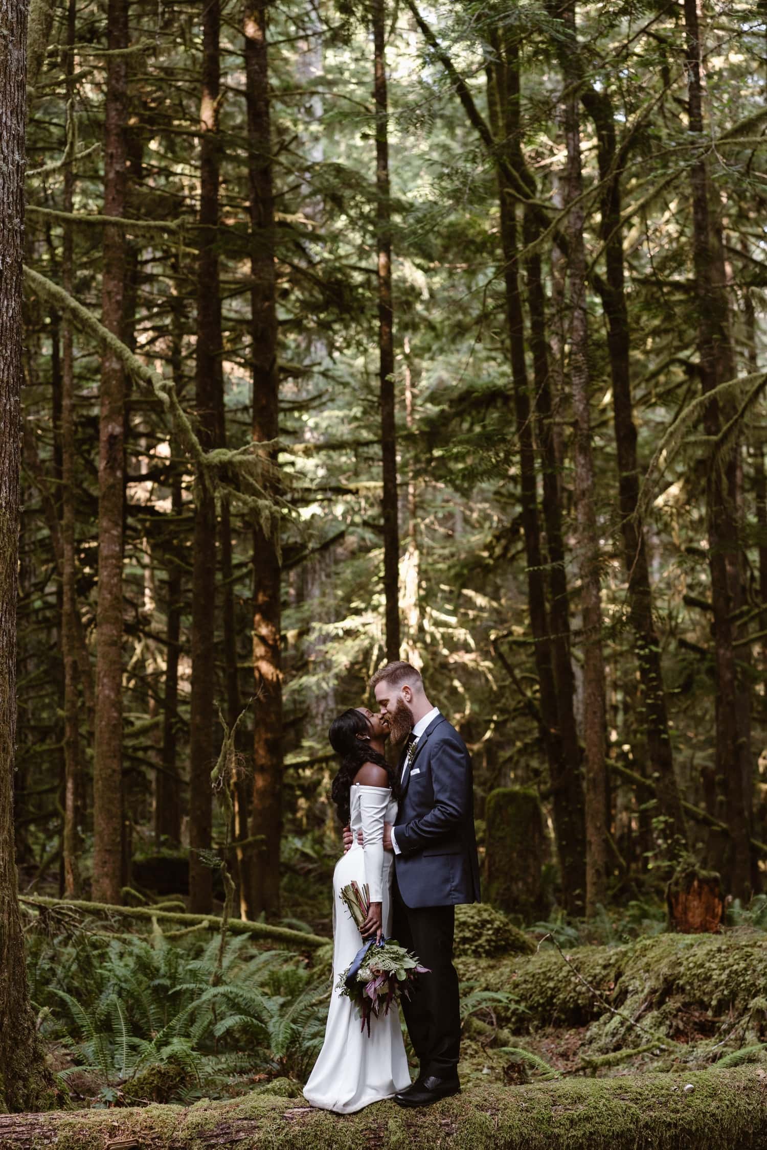 Bride and Groom kissing in forest at Olympic National Park Elopement