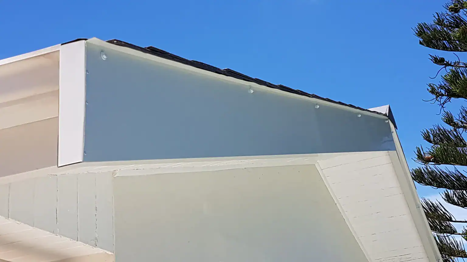 Clean white aluminium bargeboard and fascia cladding restoration providing a sleek architectural finish.
